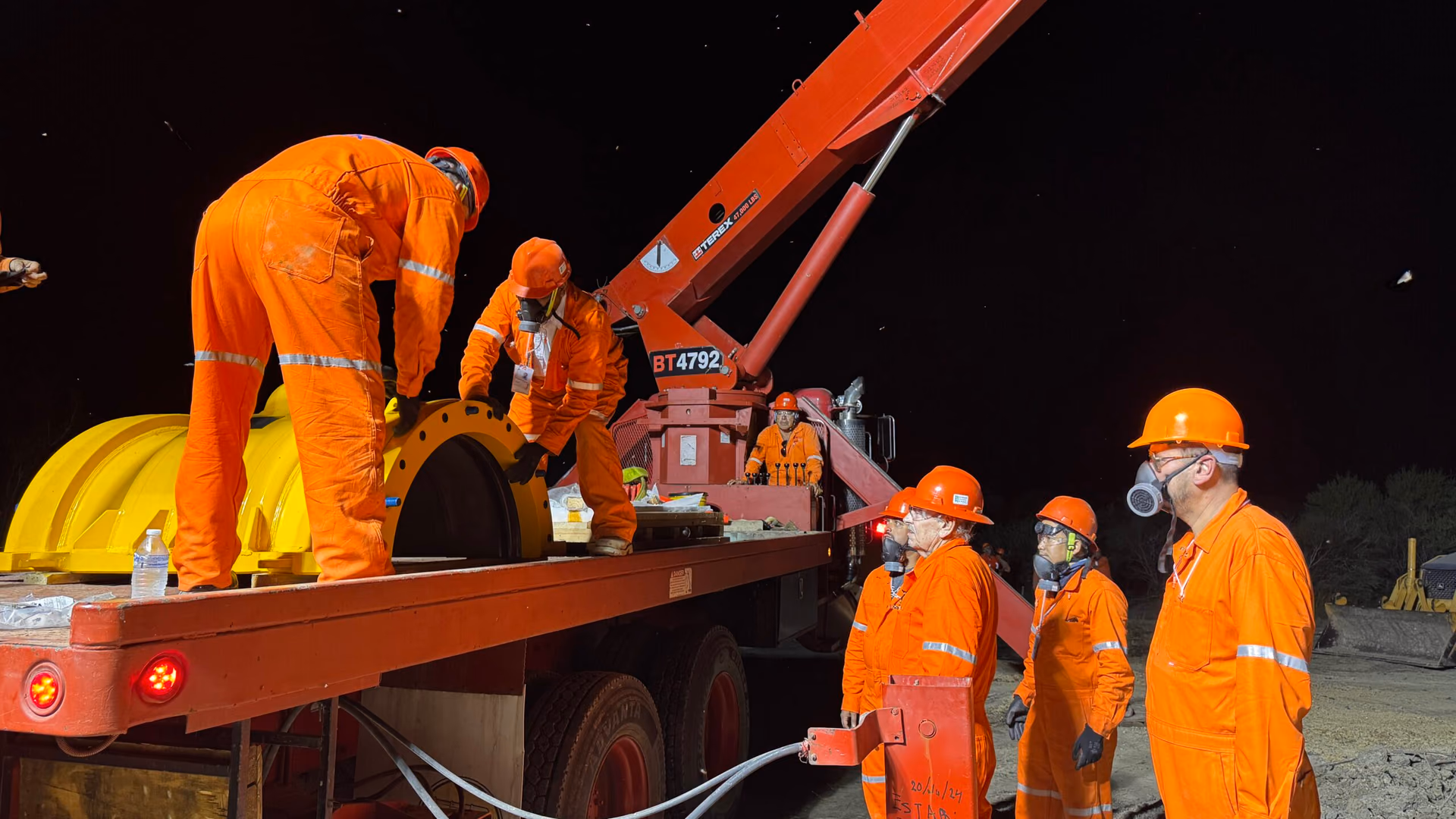 Crew preparing a bolted sleeve installation in the field